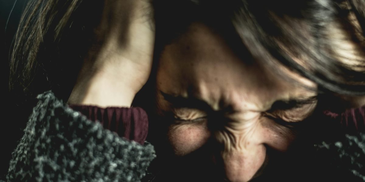 A person reflecting on feelings of stress and the challenge of daily life.