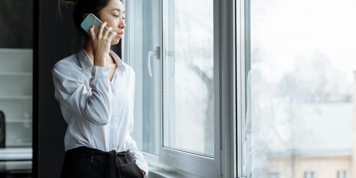 A person looking determined and making a phone call, symbolizing the initial step towards seeking help.