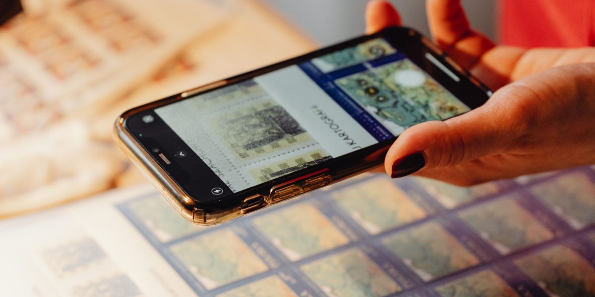 A person curating a personal collection of calming images on their device for anxiety relief.