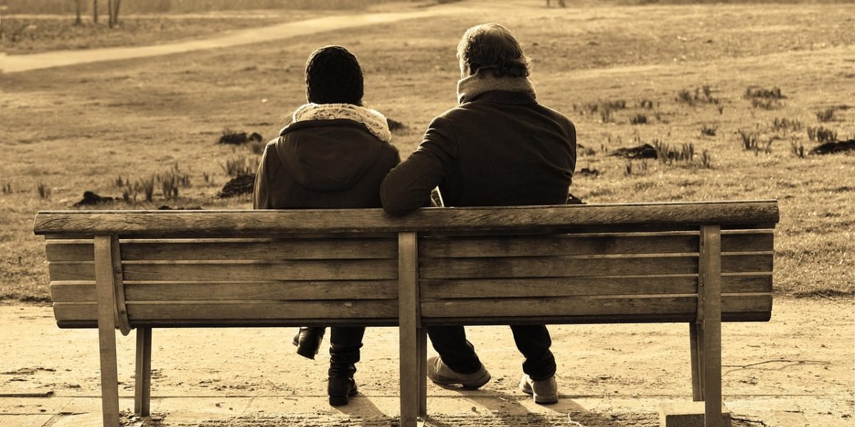 A couple engages in a calm discussion with a neutral counselor, seeking perspective.