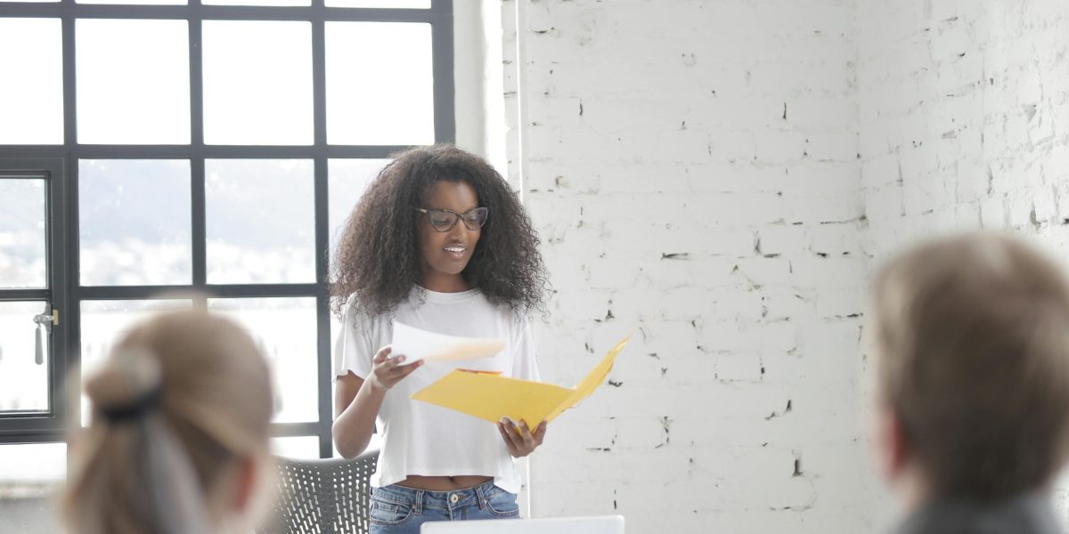 A person confidently engaging in a group meeting, representing success in managing social anxiety.