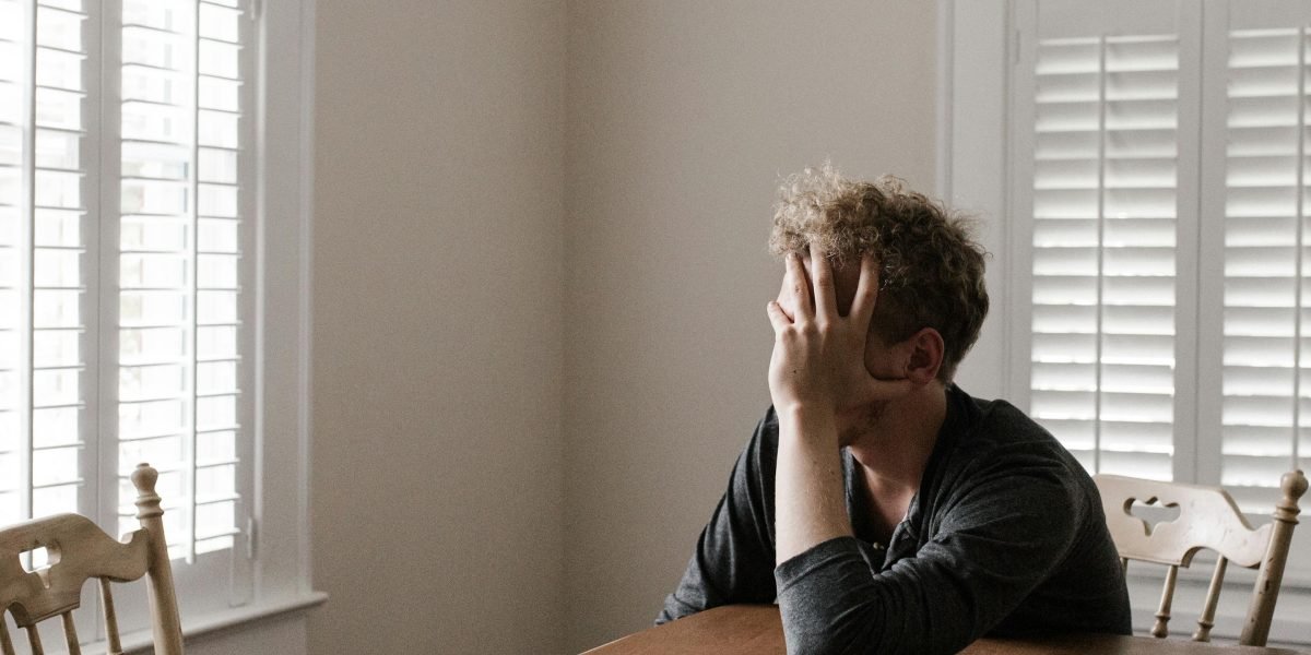 An individual experiencing feelings of being overwhelmed, reflecting the struggle with complex stress disorder.