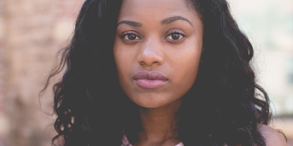A person smiles confidently, reflecting a sense of progress and hope after addressing mental health.