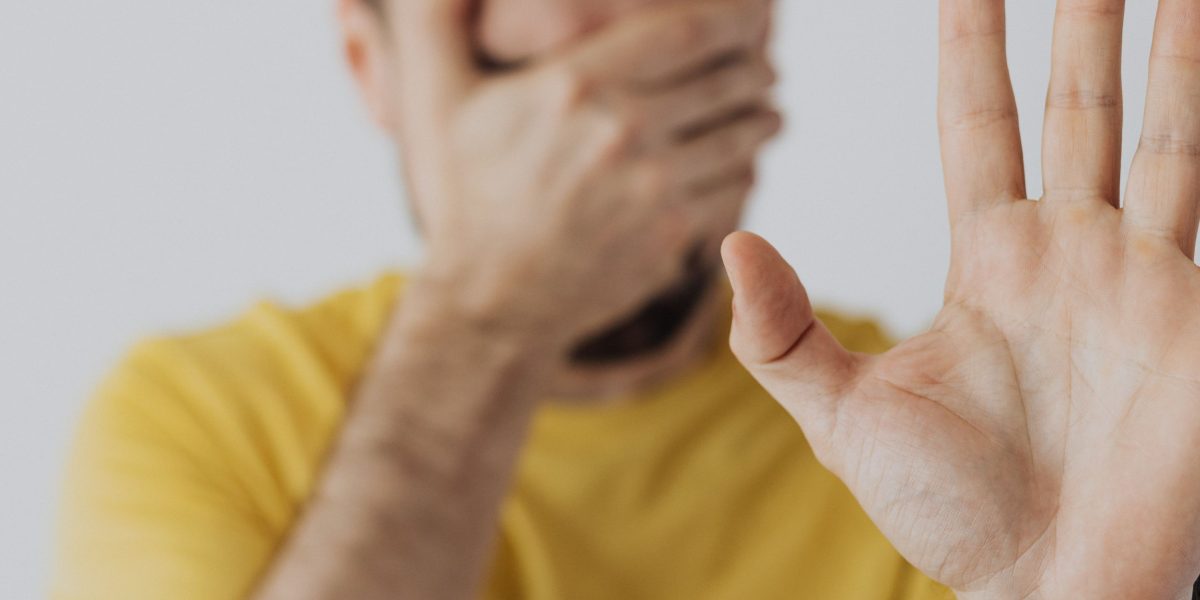 An individual looking hesitant or withdrawn, representing the avoidance behaviors common in social anxiety.
