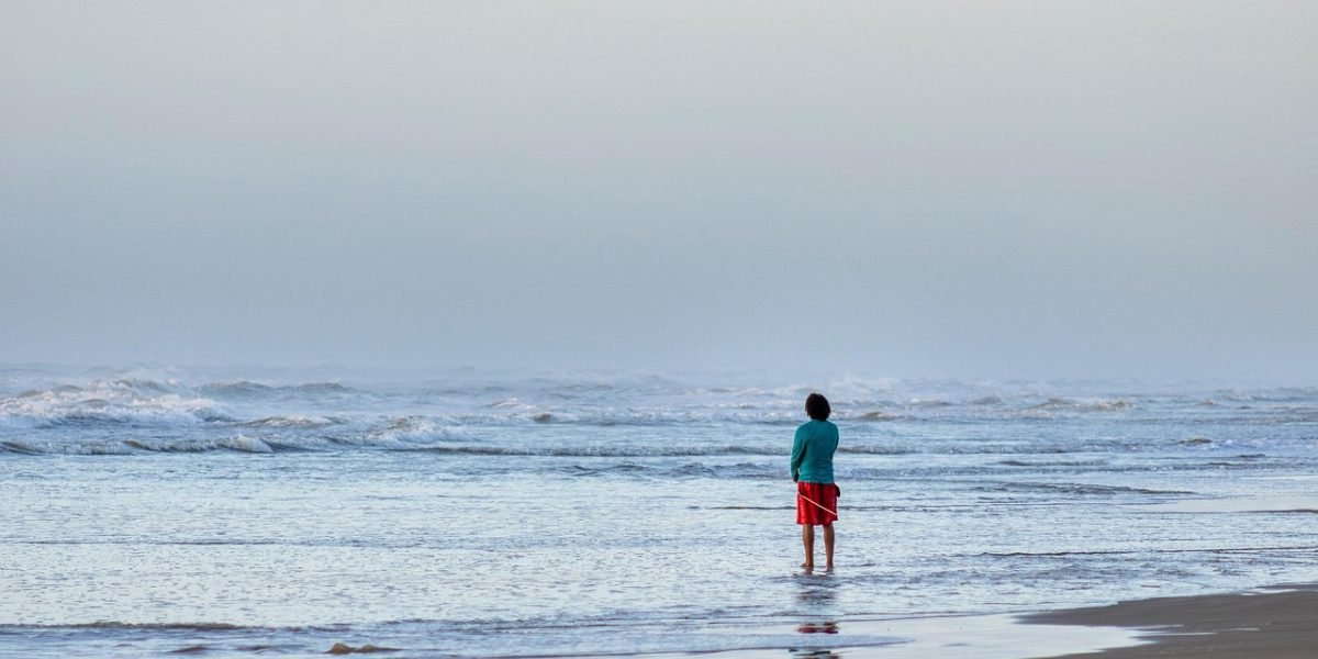A person looking out thoughtfully, embodying a sense of calm and introspection after understanding their feelings.