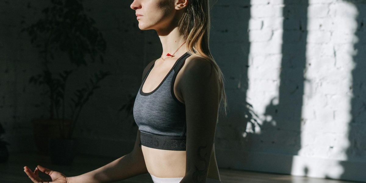 A person calmly practicing deep breathing in a serene environment, demonstrating an immediate coping strategy for anxiety.
