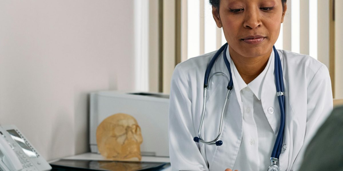 A family and their teenager consulting with a doctor or pediatrician about health concerns.
