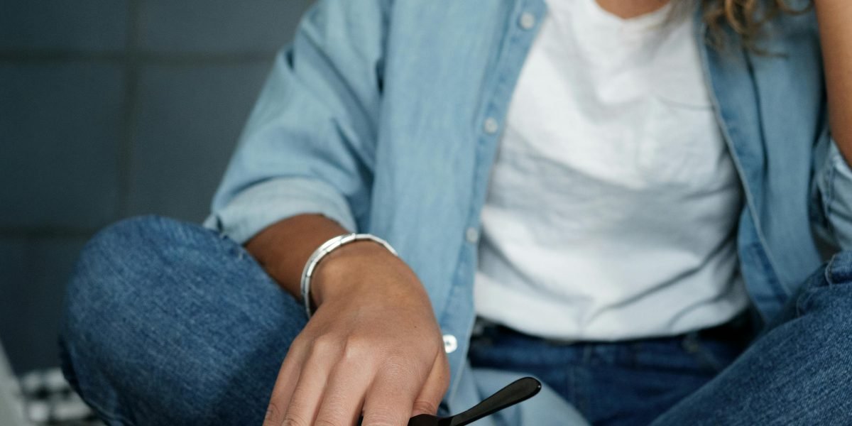 A person focused on a tablet or computer, thoughtfully searching for mental health support, representing the online search for a therapist.