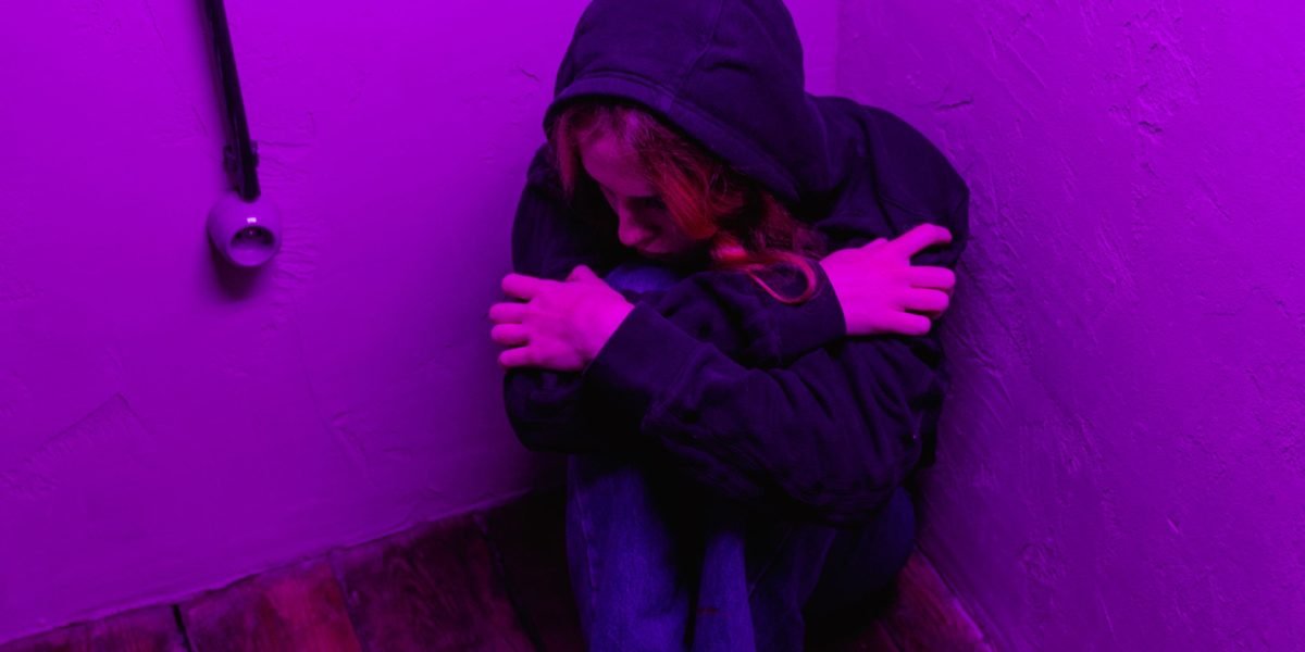 A teenager looking contemplative and slightly isolated, illustrating social withdrawal and internal struggles with anxiety.
