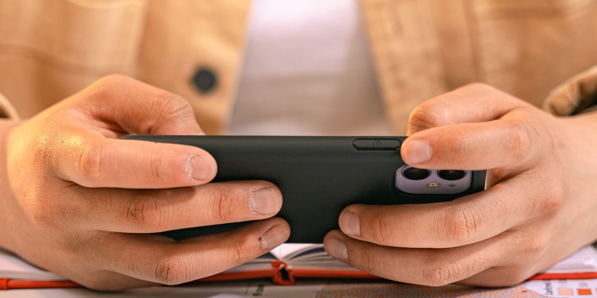 A person carefully reviewing different sleep tracking apps on their smartphone to find the best fit.