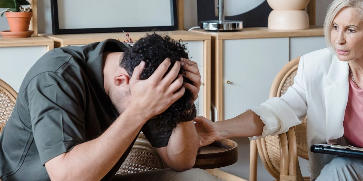 A person engages in a supportive conversation with a mental health professional, seeking guidance for anxiety.