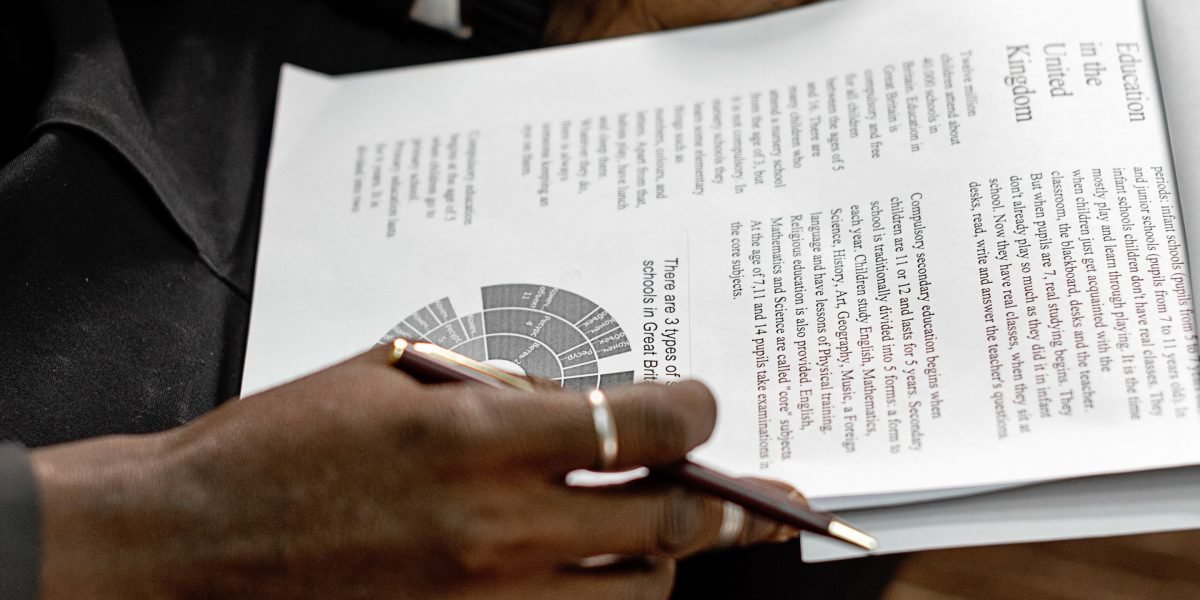 A mental health provider carefully reviewing documents, reflecting the complexity of navigating healthcare systems.