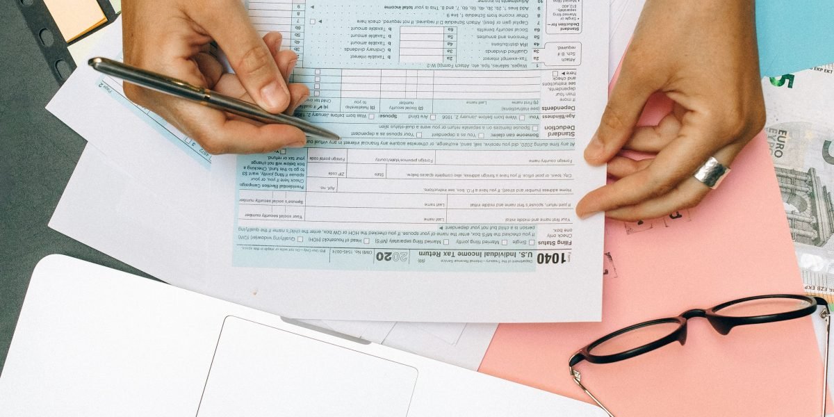 A person organizing financial documents, symbolizing efficient billing and reimbursement practices for a healthcare provider.
