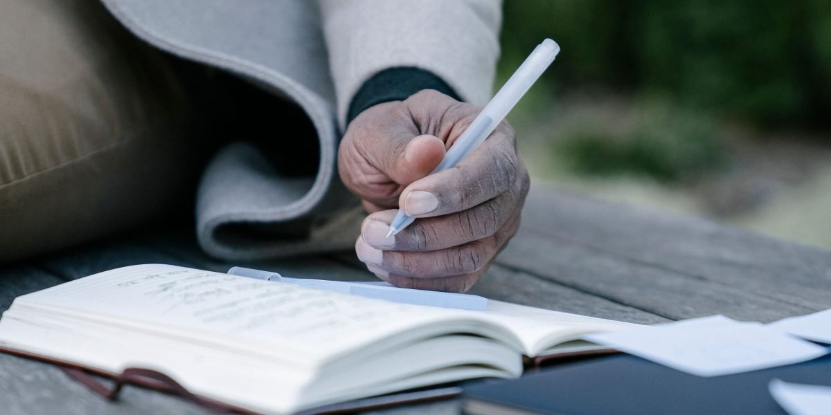 A person mindfully writing in a notebook, engaging in journaling to process thoughts and reduce worries.