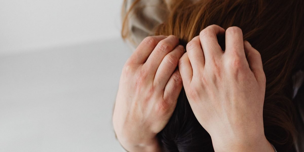 A person experiencing internal stress or overwhelm, reflecting the biological reactions of the nervous system to anxiety.