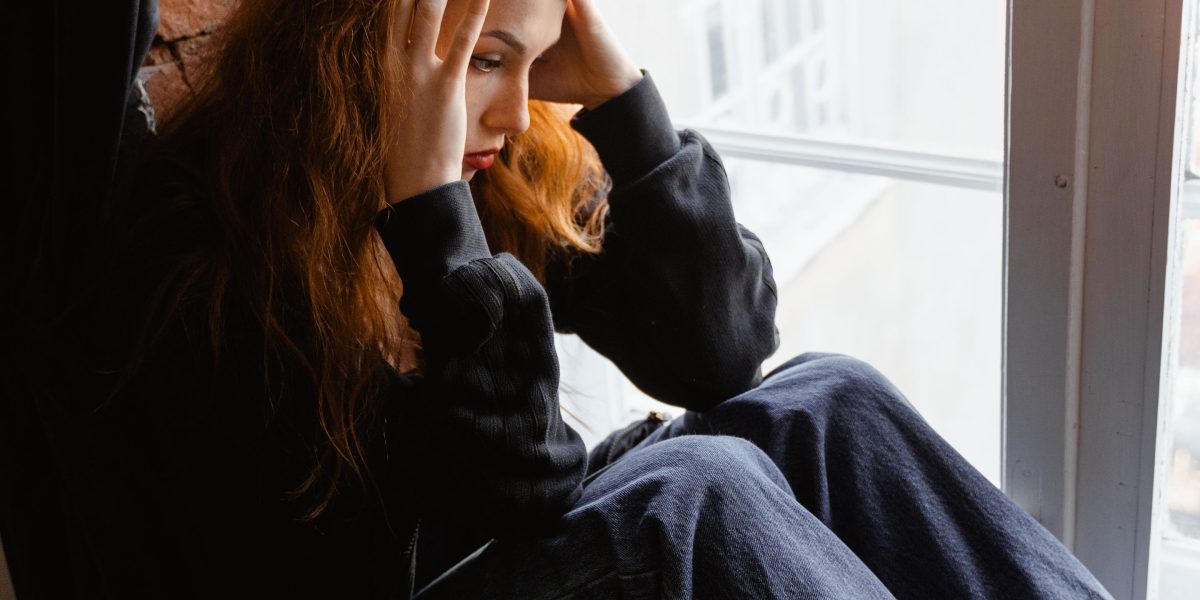 A person quietly reflecting, embodying the internal struggle of anxious feelings but also the hope for understanding and relief.