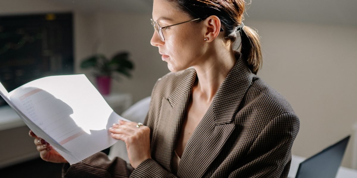 A person carefully reviewing documents, symbolizing the act of understanding complex medical information and feeling empowered.