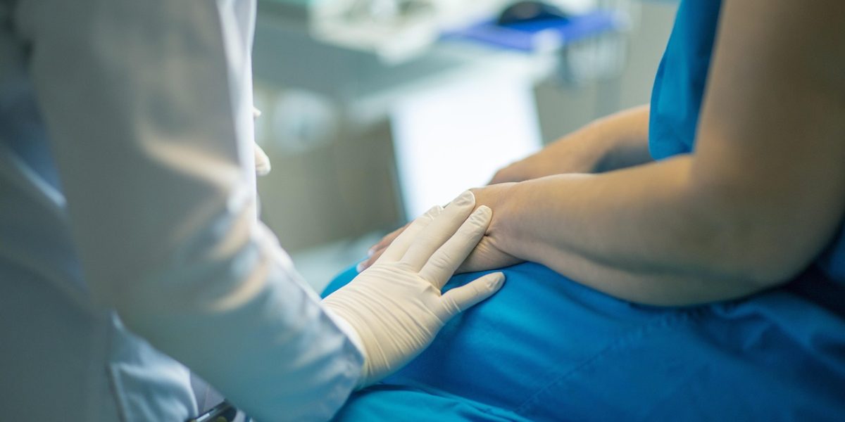 A doctor and patient engaged in a calm discussion in a consultation room, emphasizing the thorough diagnostic process.