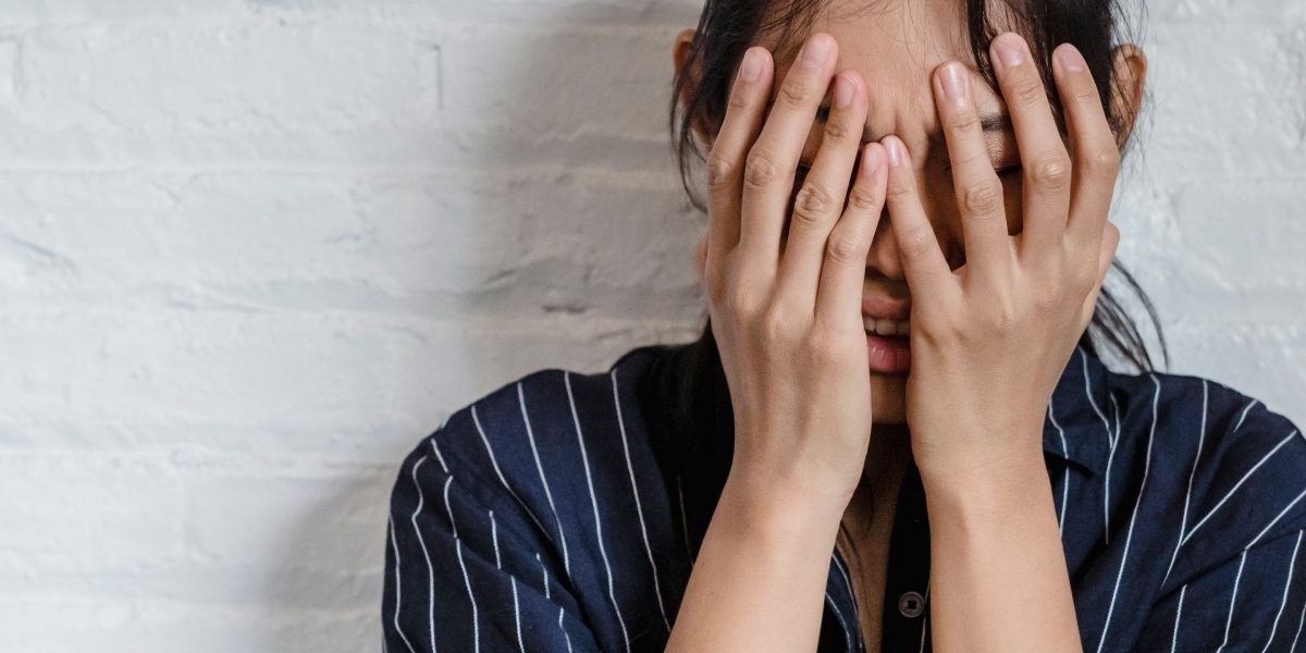 A person appears distressed, reflecting the mental state of someone experiencing acute stress.