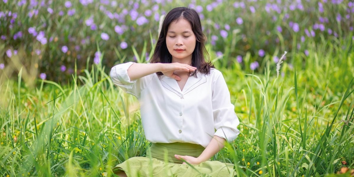 A person engaging in deep breathing or mindfulness exercises, demonstrating a self-care strategy.