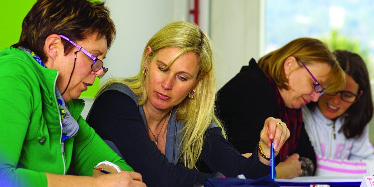 Individuals participating in a group discussion, highlighting the community aspect of residential treatment.