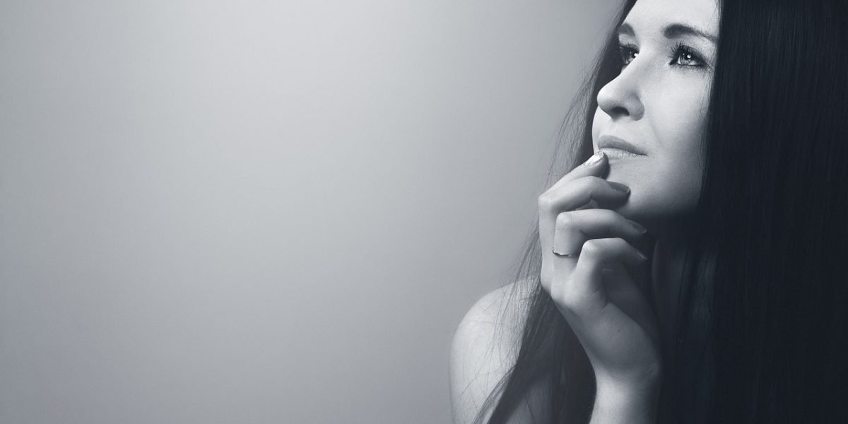 A person sits quietly, reflecting on their feelings and experiences, seeking clarity.