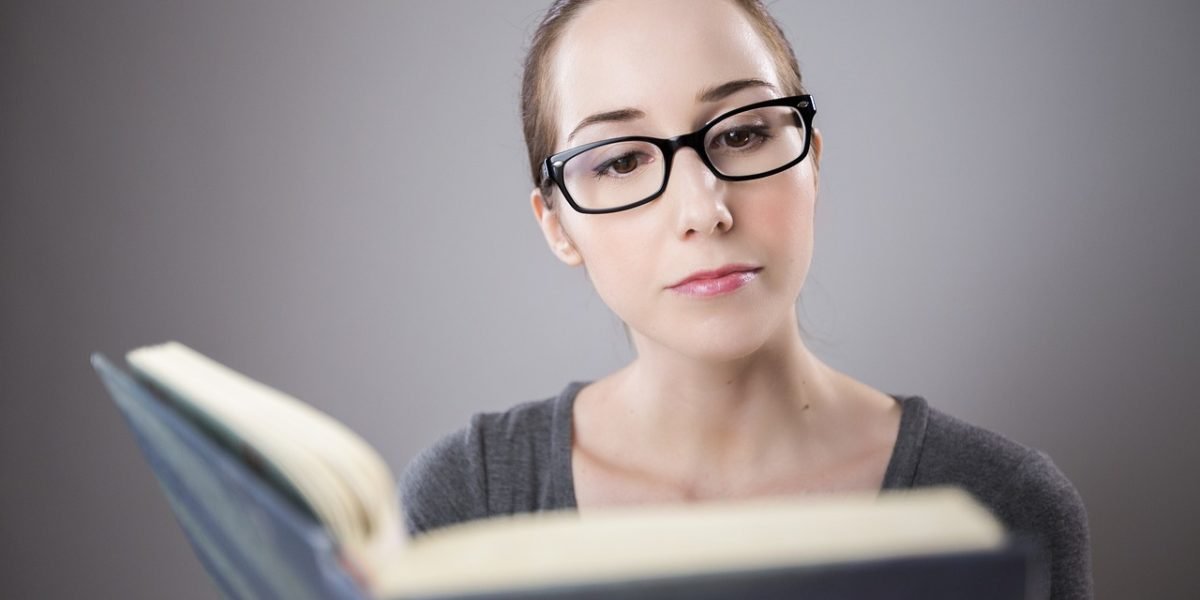 A student looking frustrated or anxious while trying to read, illustrating academic challenges due to specific phobias.
